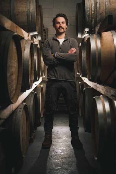 Stu with arms crossed in barrel room