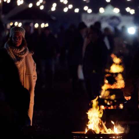 Lady standing by fire at Fireside yarra valley event